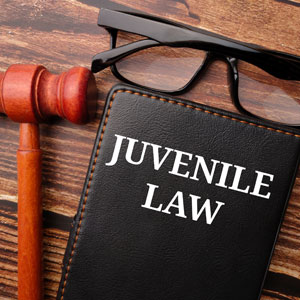 A text "juvenile law" in bold, on a book, represents Juvenile Crimes - Law Office Of Jeffrey W. Johnson