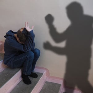  A man sitting on stairs, his shadow cast beside him. Symbolic image representing neglect and abuse - Law Office Of Jeffrey W. Johnson.